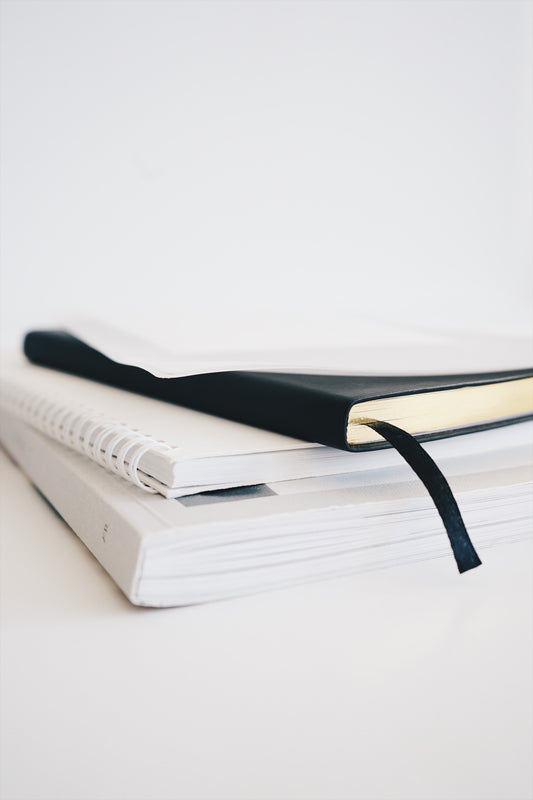 white desk with agenda notebook desk accessories daily planner organized time-saving hack tips